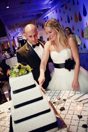 The bride and groom cutting the cake at the reception