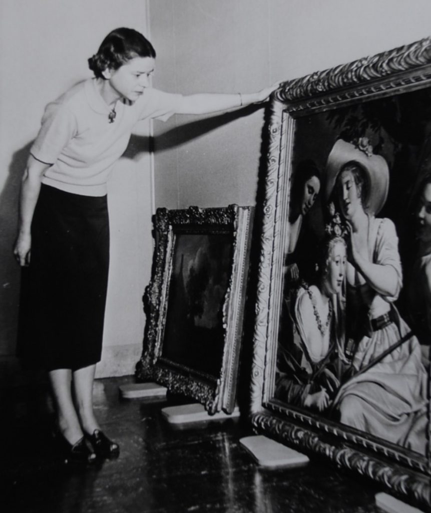 Dottie Malone examining the painting