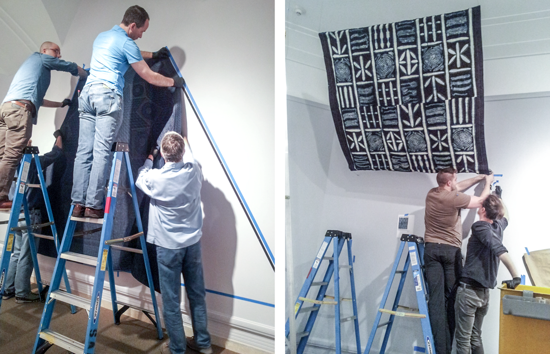 The SAM team hanging tapestries