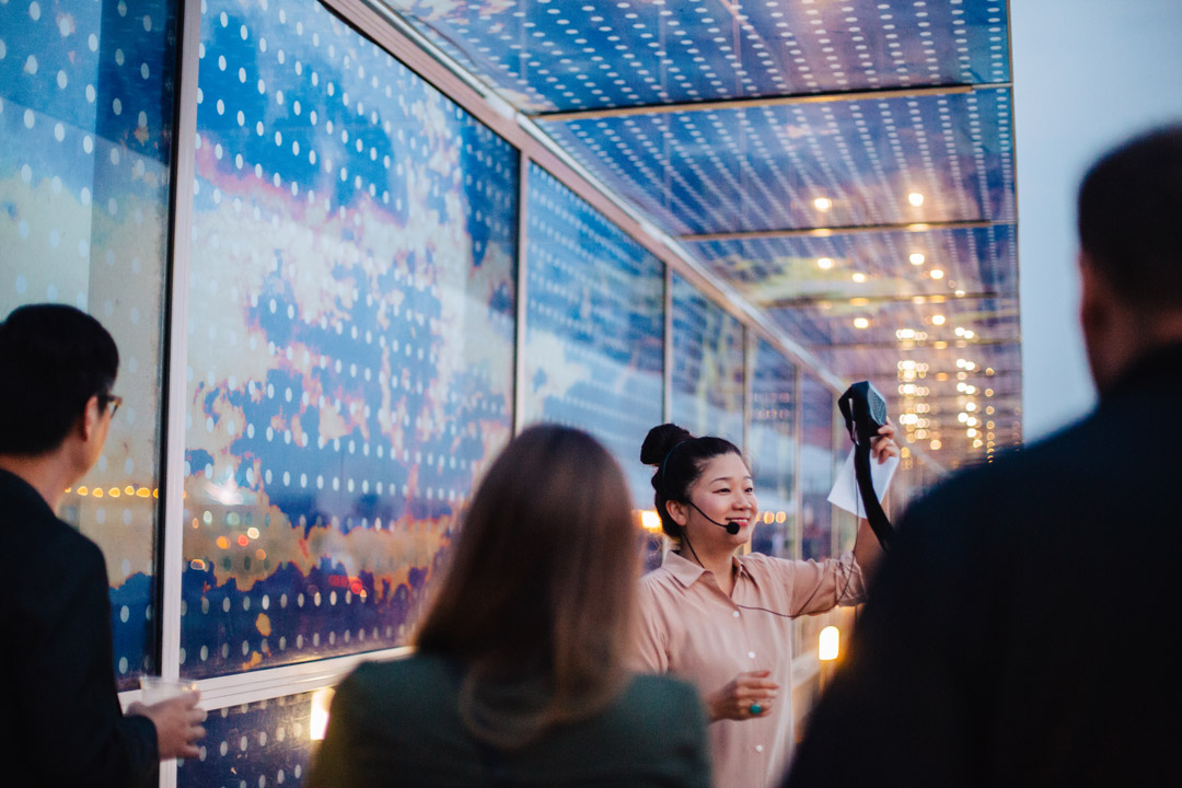 Woman gives a tour in front of Fernandez's Seattle Cloud Cover during Remix at Olympic Sculpture Park