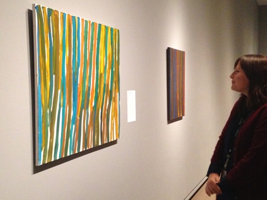 Katie Morris, looking at paintings by Emily Kngwarreye, promised gifts of Margaret Levi and Robert Kaplan, all paintings © Emily Kngwarreye. Currently on view in the Australian Aboriginal art gallery, Seattle Art Museum.