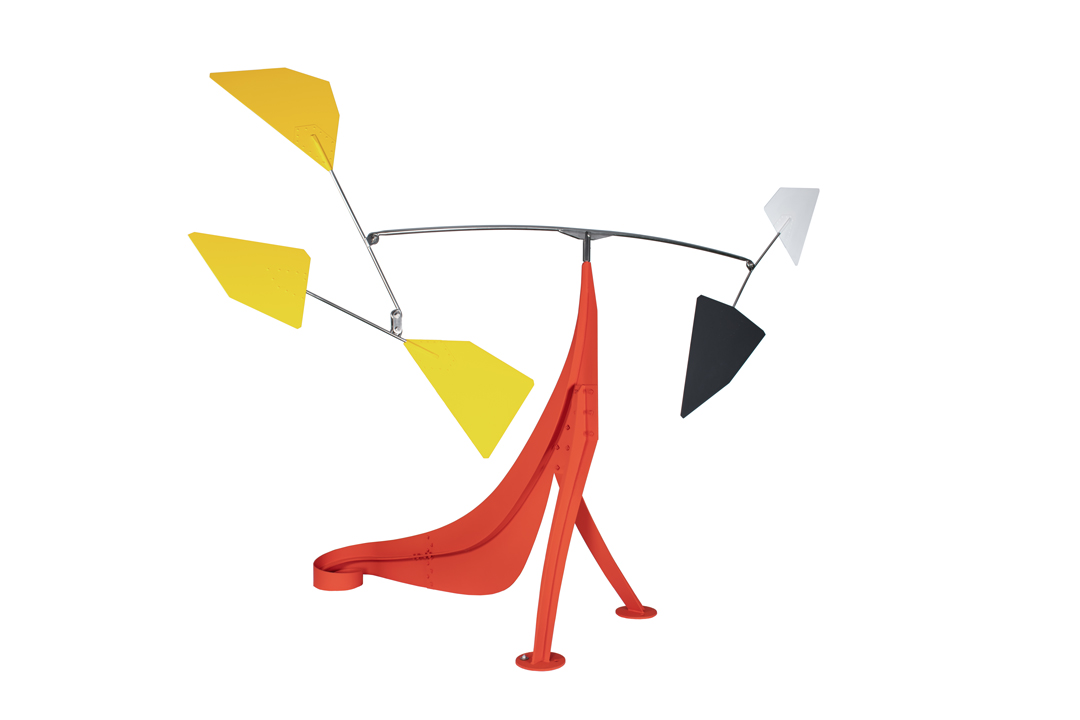 An Alexander Calder mobile scultpure with a central red figure with curled base and floating mobile shapes in yellow, white, and black