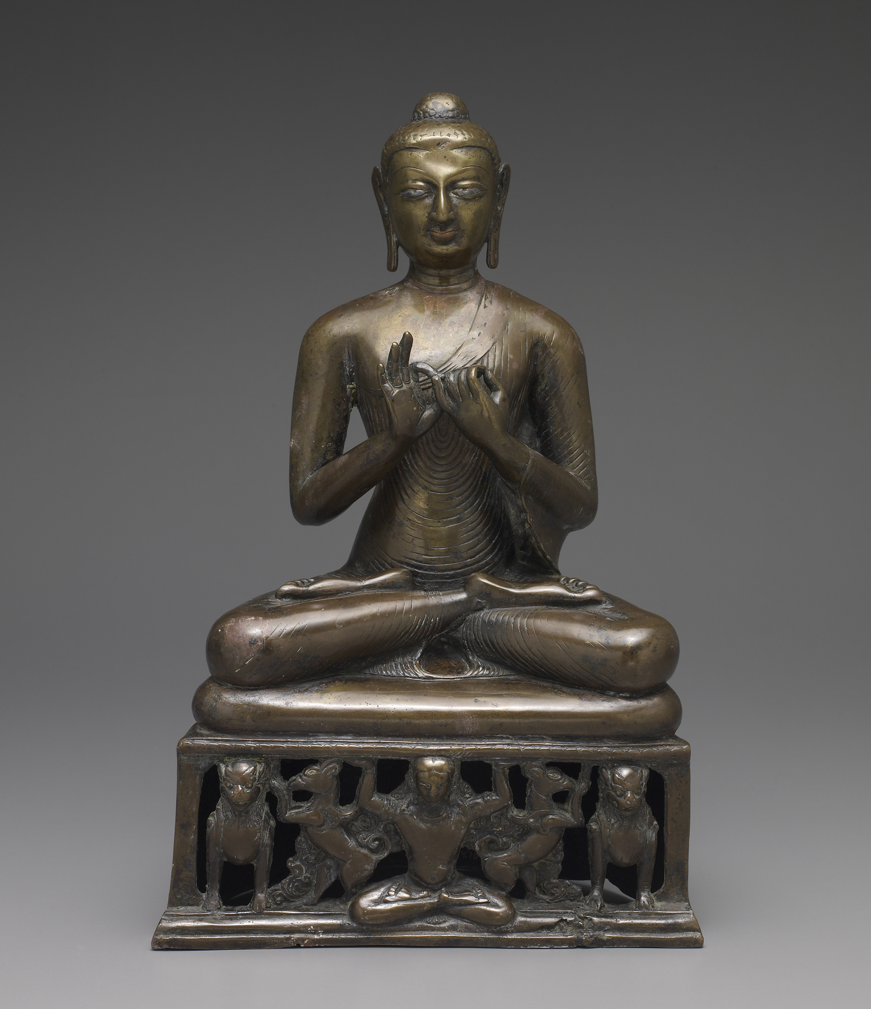 An image of a seated buddha sculpture sitting in Lotus pose