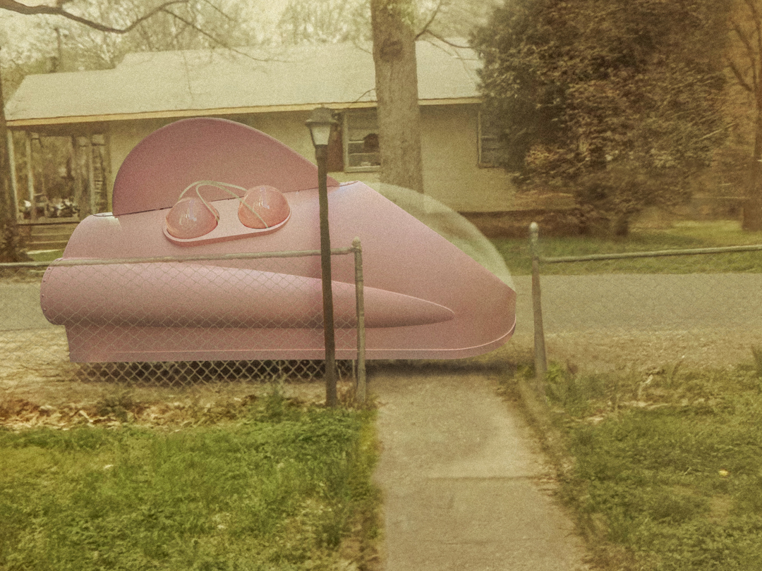 A pink spaceship parked on the sidewalk at the end of a paved walkway.